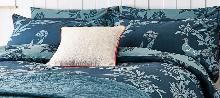 Joules Country Critters bedding: A dark teal duvet cover set, decorated with a large contrasting lighter flower pattern, interspersed with rabbits and pheasants.