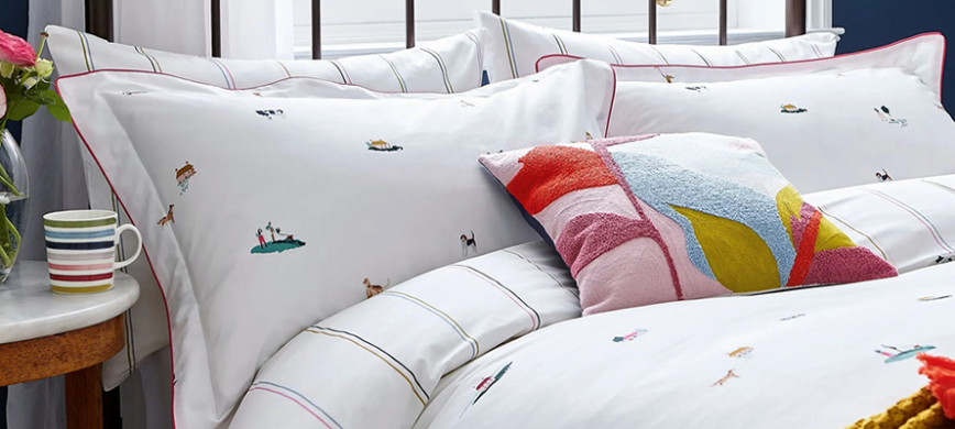 Joules Countryside Scene bedding: A crisp, white duvet set featuring delicate hand-drawn countryside inspired scenes, including animals, people and cottages.