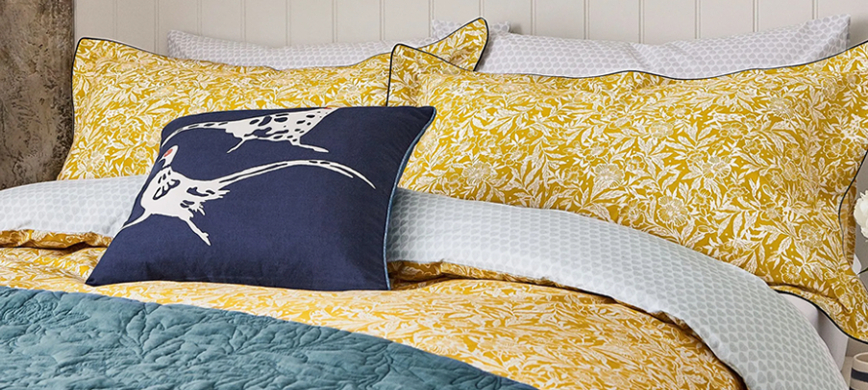 Joules Twilight Ditsy bedding: A cheerful yellow duvet cover with a delicate white leafy pattern.