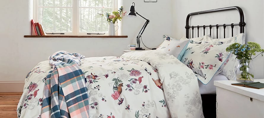 Joules Woodland Floral bedding: A white duvet cover with a hand-painted floral and animal pattern.