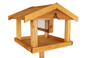 Wooden bird table with roof and a built-in mesh food holder.